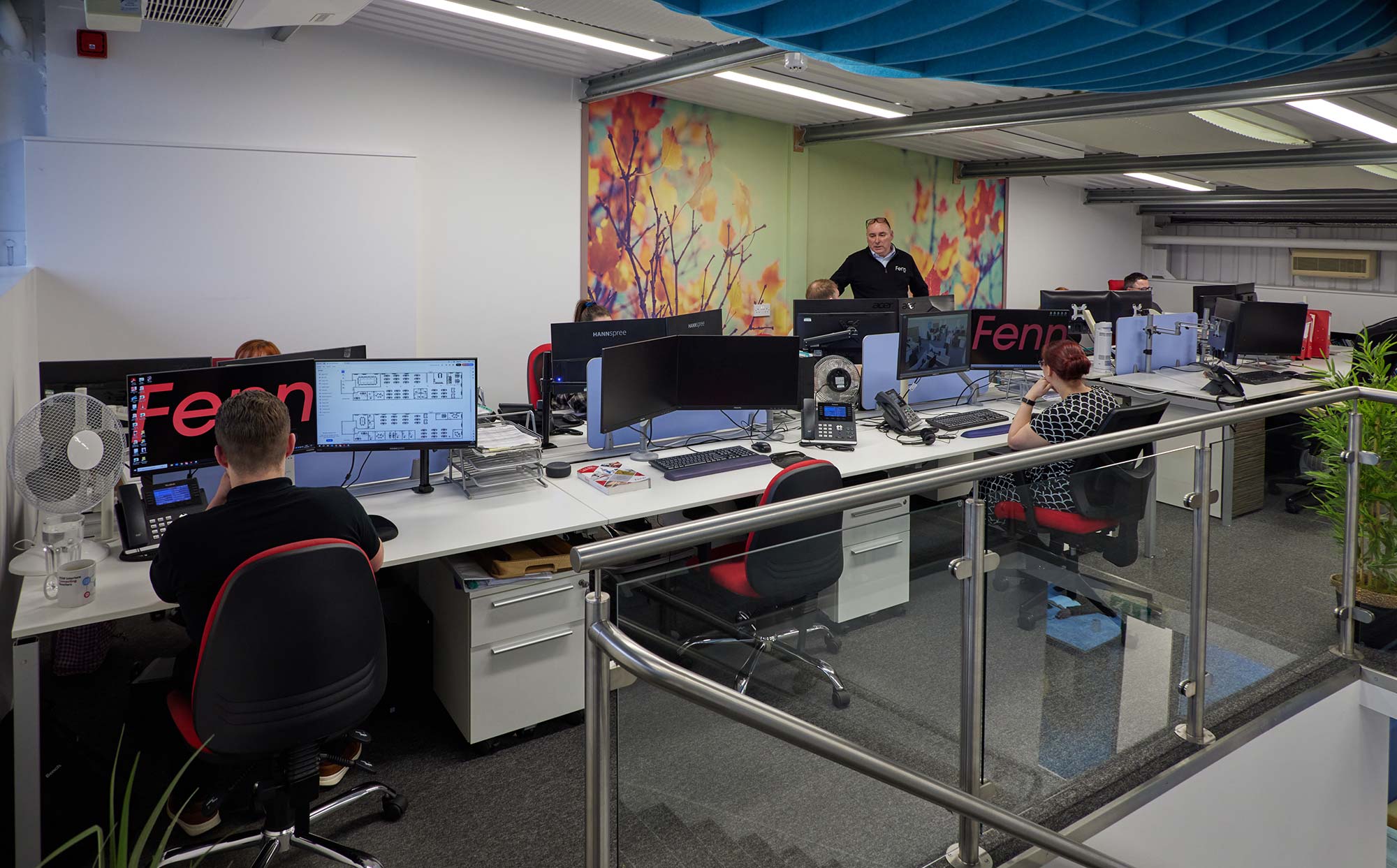 Fenn's office featuring multiple staff at their desk working on computers.